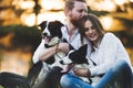 Beautiful couple walking dogs and bonding in nature Royalty Free Stock Photo