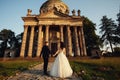 Beautiful couple in wedding dress outdoors near the antique victorian church Royalty Free Stock Photo