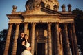 Beautiful couple in wedding dress outdoors near antique victorian church Royalty Free Stock Photo