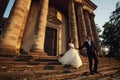 Beautiful couple in wedding dress outdoors near the victorian church