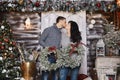 Beautiful couple of young lovers kissing in the interior decorated for Christmas holidays Royalty Free Stock Photo
