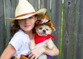 Beautiful cowboy kid girl holding chihuahua with sheriff hat Royalty Free Stock Photo