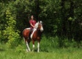 Beautiful cowgirl bareback ride her horse in woods glade Royalty Free Stock Photo