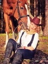 Beautiful cowgirl with her red horse Royalty Free Stock Photo