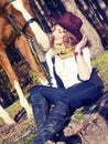 Beautiful cowgirl with her red horse Royalty Free Stock Photo