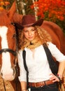 Beautiful cowgirl with her red horse. soft focus Royalty Free Stock Photo