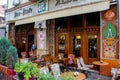 A beautiful and cozy cafe with people sitting at tables and waiters in the capital of Albania - Tirana. Albanian cuisine