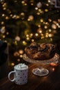 Beautiful and cozy Christmas breakfast consisting of home baked chocolate wreath with hot cocoa in a cute dotted cup.