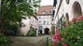 Beautiful cozy courtyard with plants and flowers in the street of old town, Lubeck, Germany Royalty Free Stock Photo