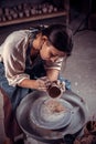 Beautiful craftsman master works with clay on a potter`s wheel. Inspiration and creativity.