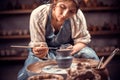 Beautiful craftsman molding a vase of clay on a potter`s wheel. Pottery workshop.