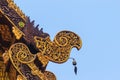 Beautiful craved naga pattern on the rafter and gable of the Tha