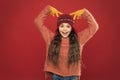 Beautiful crazy. Crazy child show horns on head. Happy girl with crazy look red background. Crazy holiday mood. Winter