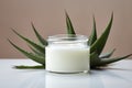 Beautiful cream bottle with beauty products aloe green leaves on white background. Natural organic skin care