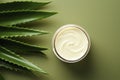 Beautiful cream bottle with beauty products aloe leaves on green background. Natural organic skin care