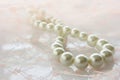 Beautiful creamy pearl necklace on lace Royalty Free Stock Photo