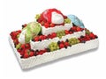 Beautiful creamy rectangular cake with fresh berries and masks