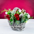 Beautiful creative winter bouquet with red and green flowers, pi