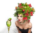 Beautiful creative Xmas makeup and hair style indoor shot. Beauty Fashion Model Girl with green parrot Royalty Free Stock Photo