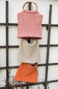 Beautiful crocheted old pink and creme hand made handbags behind the wall