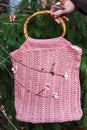 Beautiful crocheted old pink handbag in autumn
