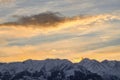 Beautiful cumulus and cirrus clouds in the blue sky during sunrise over the snow-capped mountains of the Trans-Ili Alatau Royalty Free Stock Photo