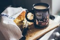 A beautiful cup of coffee with a piece of apple pie on the wooden board