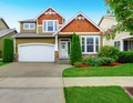 Beautiful curb appeal of American house in olive exterior paint.