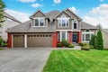 Beautiful curb appeal of beige house with red brick trim Royalty Free Stock Photo