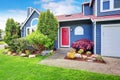 Beautiful curb appeal with blue exterior paint and red roof. Royalty Free Stock Photo