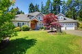 Beautiful curb appeal. Large beige house with white trim.