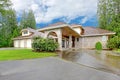 Beautiful curb appeal. Large brick house with three garage spaces and driveway with arch Royalty Free Stock Photo