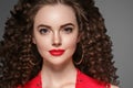 Beautiful curle hair female in red with red lips and dress manicure, beauty red afro hairstyle