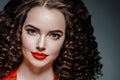 Beautiful curle hair female in red with red lips and dress manicure, beauty red afro hairstyle