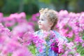 Beautiful curly baby girl playing in the garden