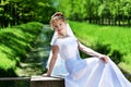 Beautiful curly bride in the park. Royalty Free Stock Photo