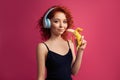 Beautiful curly girl eating a banana