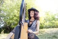 Beautiful curly hair woman playing the harp Royalty Free Stock Photo