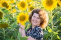 Beautiful curly-haired woman in field of sunflowers Royalty Free Stock Photo