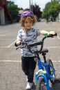 Curly haired boy with blue bike