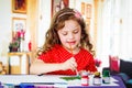 Beautiful curly little girl painting Royalty Free Stock Photo