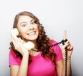 Beautiful curly woman talking on white vintage telephone Royalty Free Stock Photo