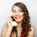 Beautiful curly woman talking on white vintage telephone Royalty Free Stock Photo