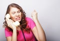 Beautiful curly woman talking on white vintage telephone Royalty Free Stock Photo