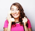 Beautiful curly woman talking on white vintage telephone Royalty Free Stock Photo