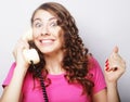 Beautiful curly woman talking on white vintage telephone Royalty Free Stock Photo