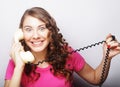 Beautiful curly woman talking on white vintage telephone Royalty Free Stock Photo