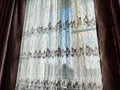 Beautiful curtains on the window with tulle, thick curtains and the sky in the background. Abstract texture, frame Royalty Free Stock Photo