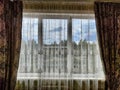 Beautiful curtains on the window with tulle, thick curtains and the sky in the background. Abstract texture, frame Royalty Free Stock Photo