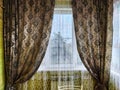 Beautiful curtains on the window with tulle, thick curtains and the sky in the background. Abstract texture, frame Royalty Free Stock Photo